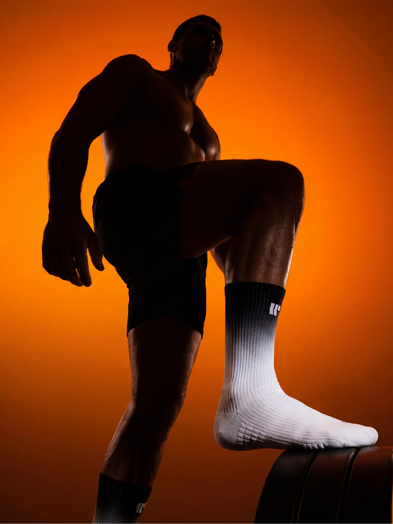 Athlete silhouette with orange backlight and product